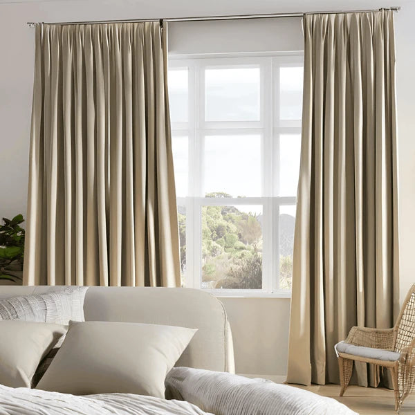 Beige blockout pinch-pleat curtains in a Sydney bedroom