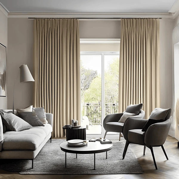 Custom pinch pleat curtains in a neutral tone installed in a modern Sydney living room, featuring elegant floor-to-ceiling draping and premium fabric.