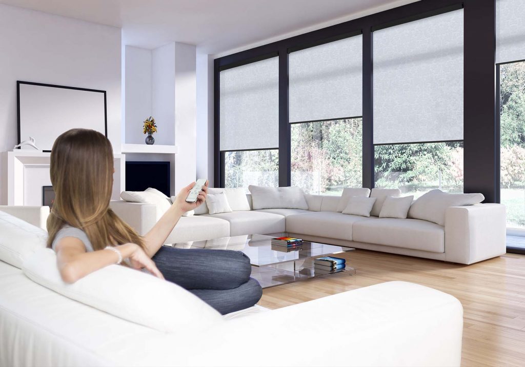 Motorised roller blinds in a modern Sydney living room — controlled by smartphone app