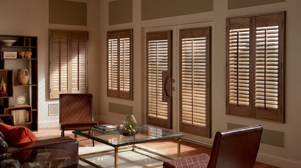 White plantation shutters with adjustable louvres on a home window