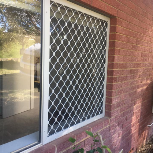 White diamond-grille security window screen on a Sydney home